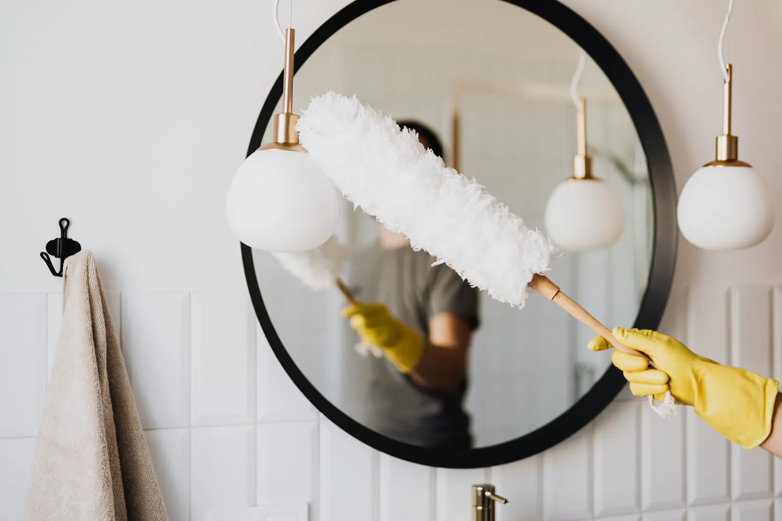 Dusting a bathroom mirror