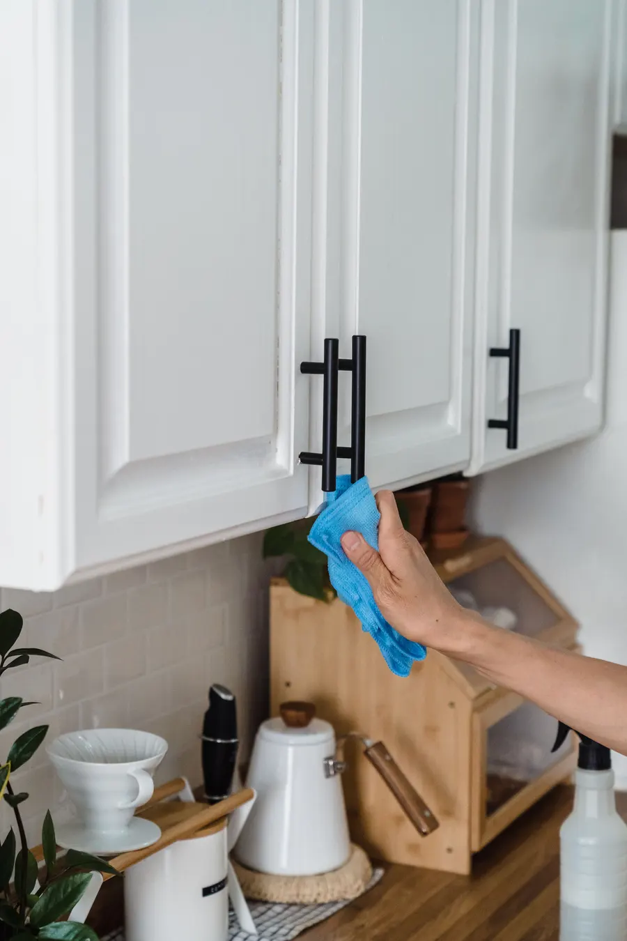 Wiping a kitchen cupboard handle